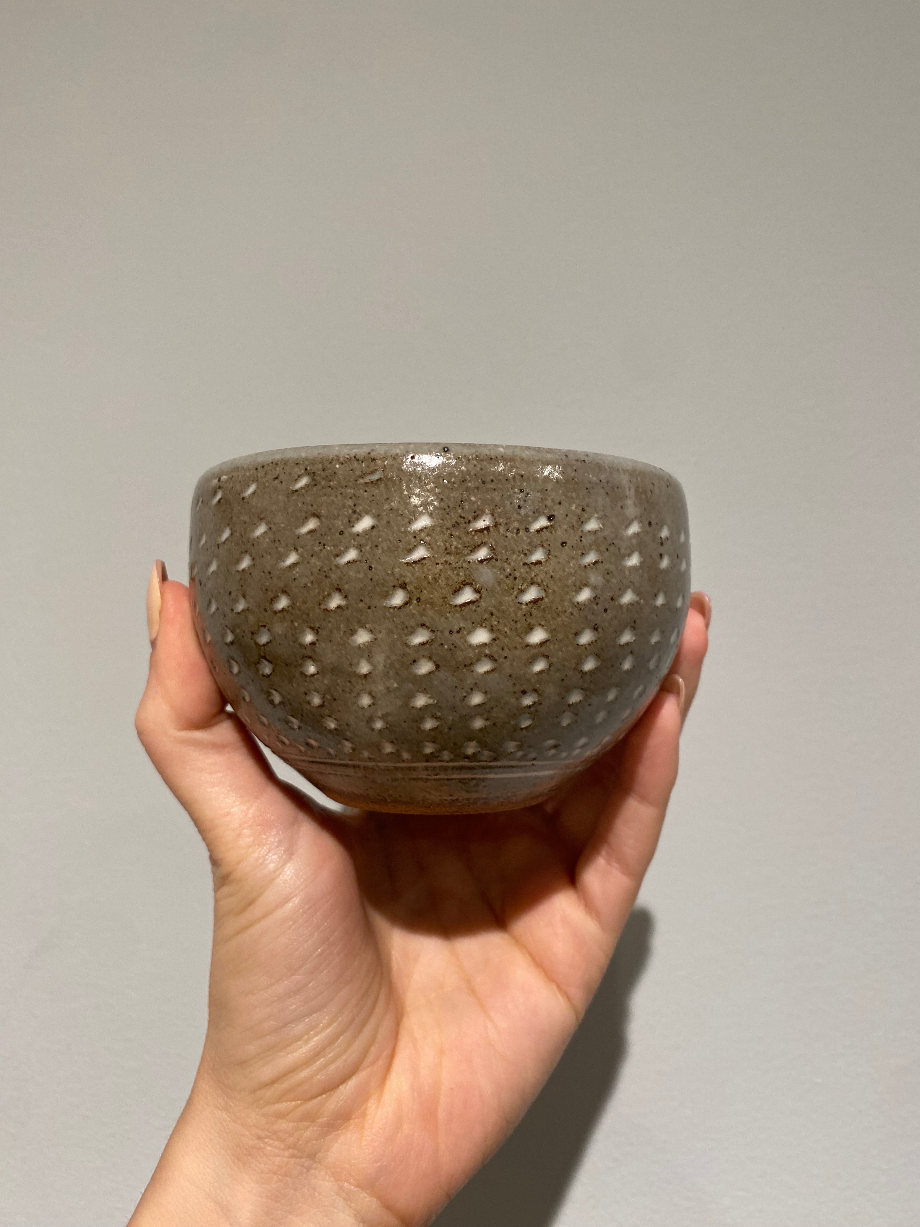 Bowl with gray glaze and white notches