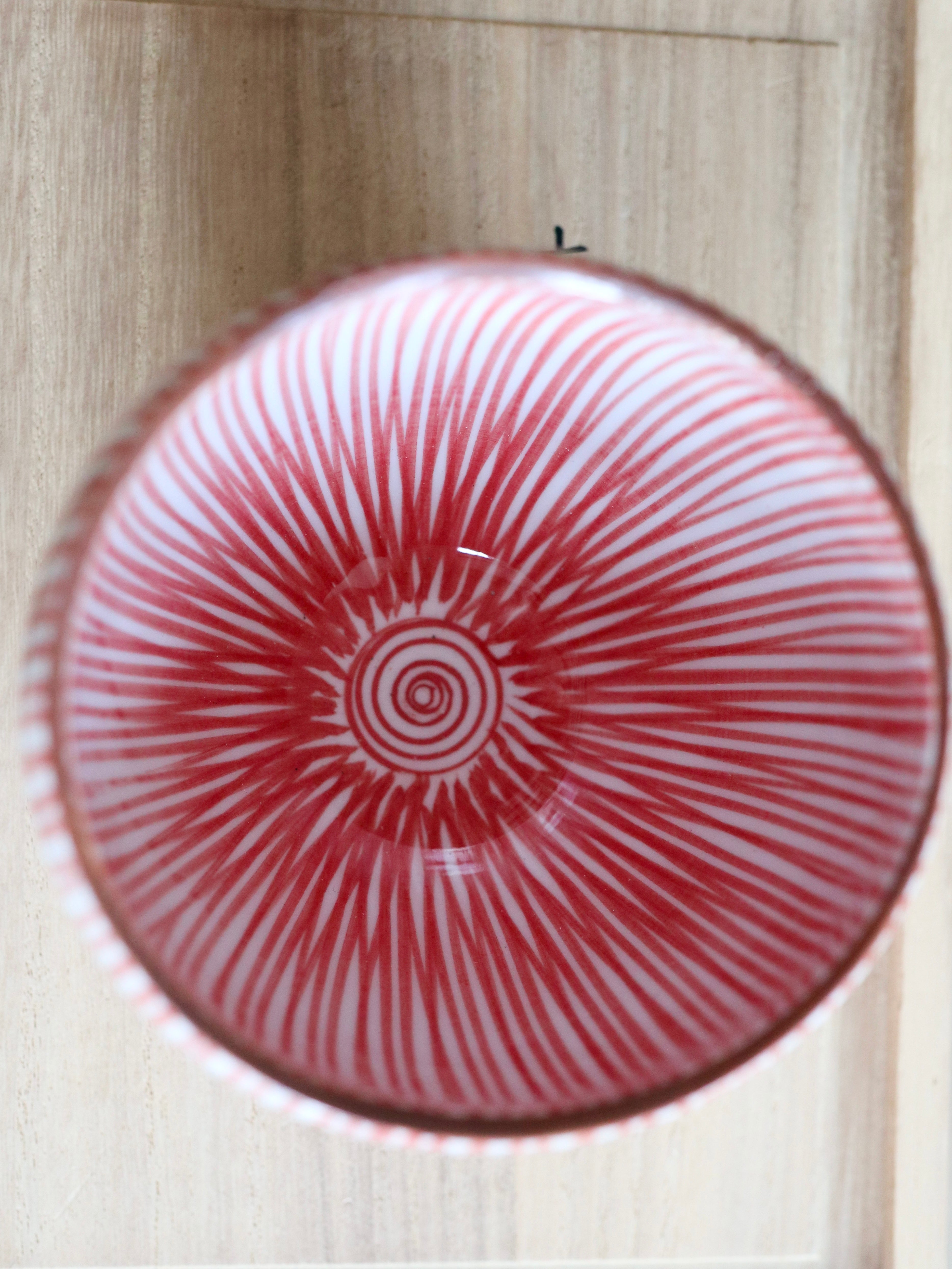 Cup with red vertical stripes and brown rim