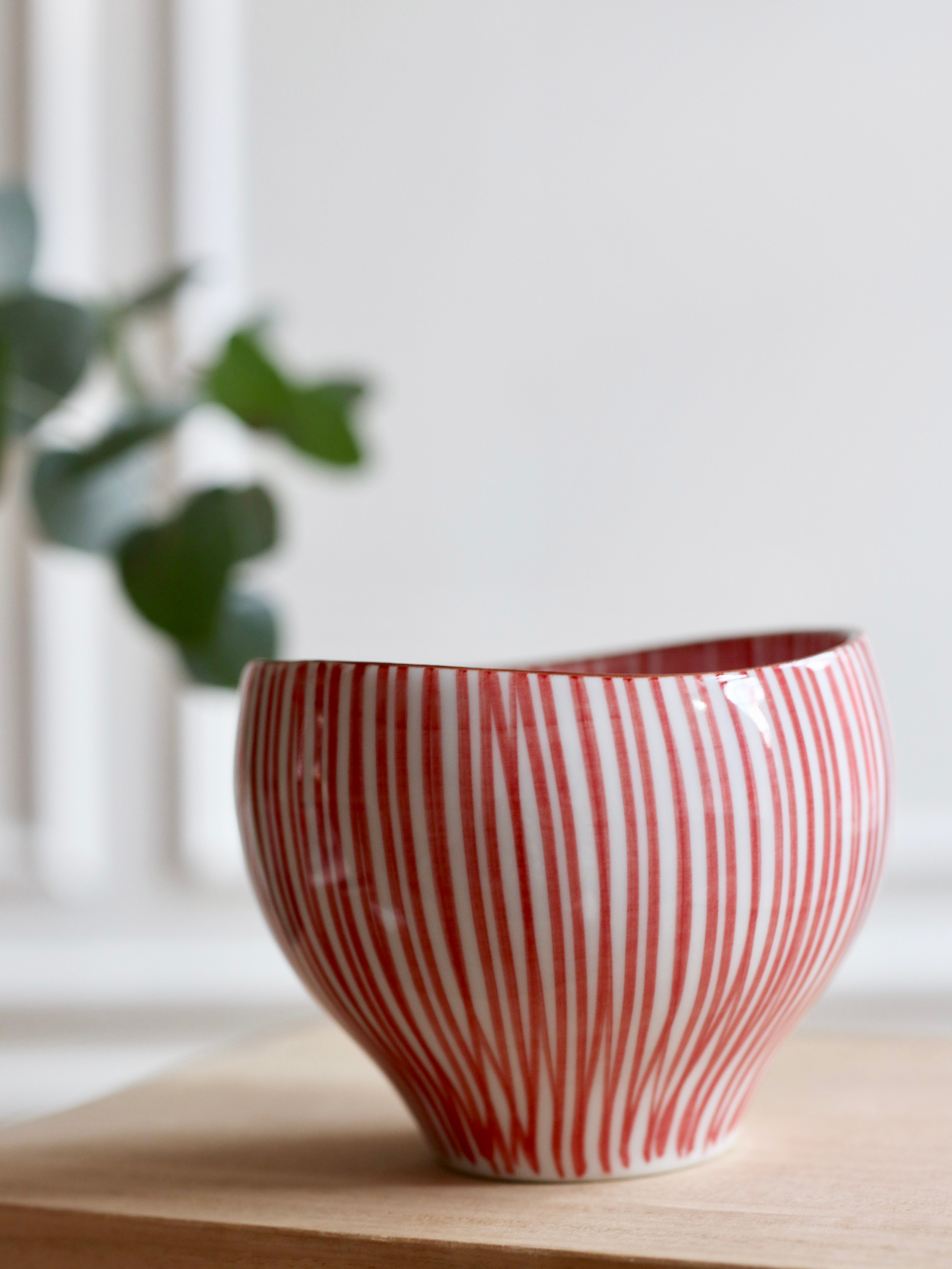 Cup with red vertical stripes and brown rim