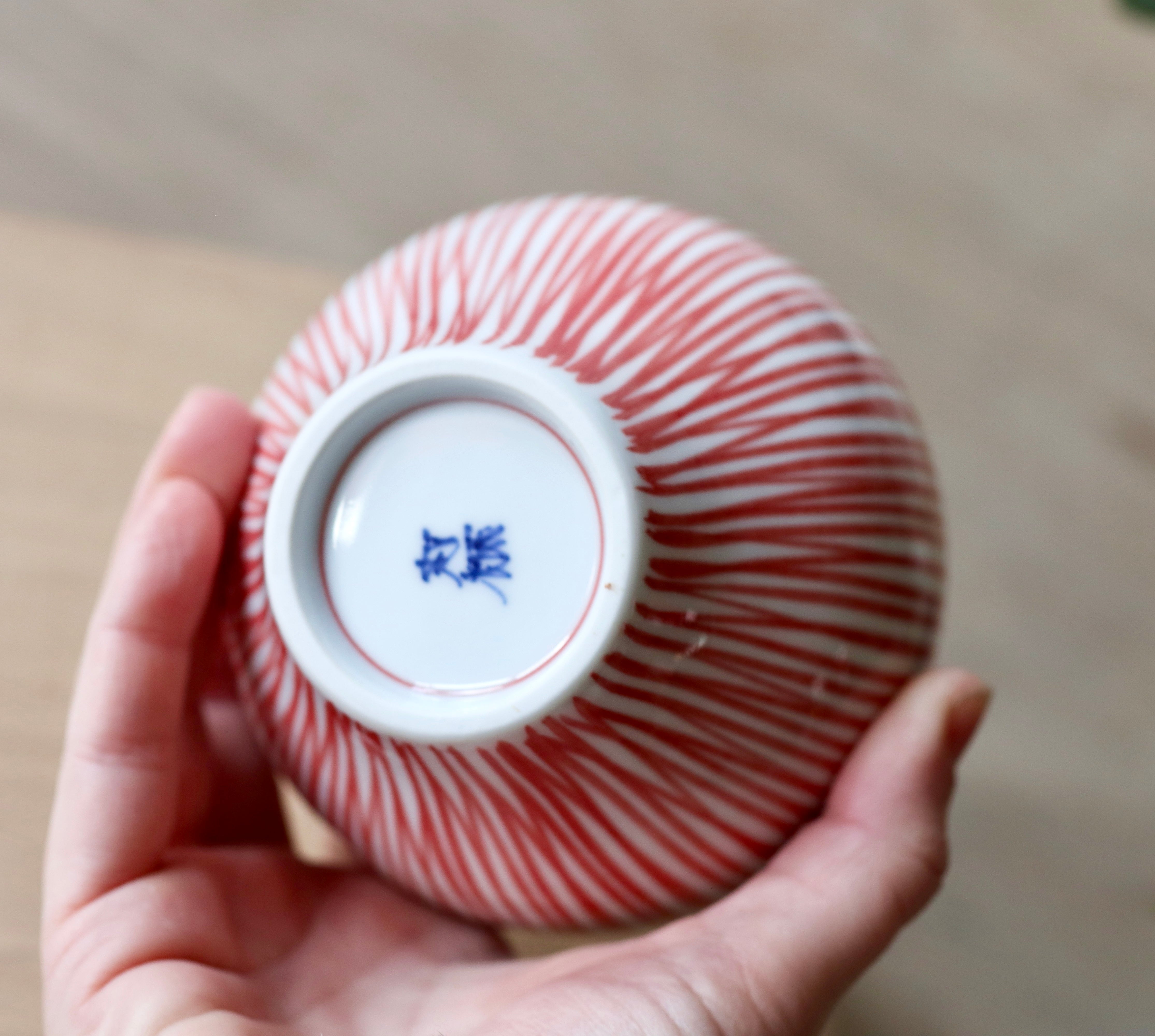 Cup with red vertical stripes and brown rim