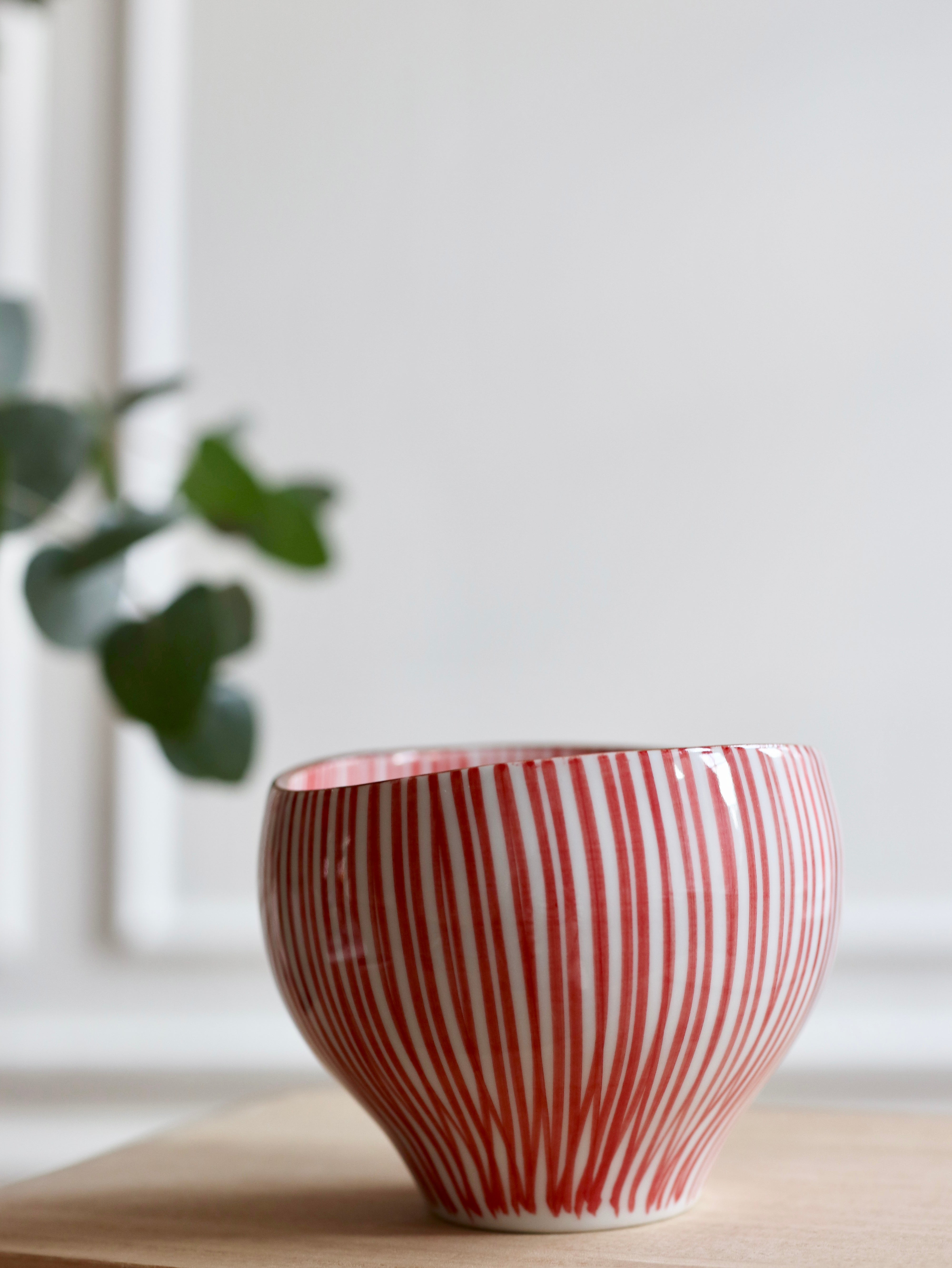 Cup with red vertical stripes and brown rim