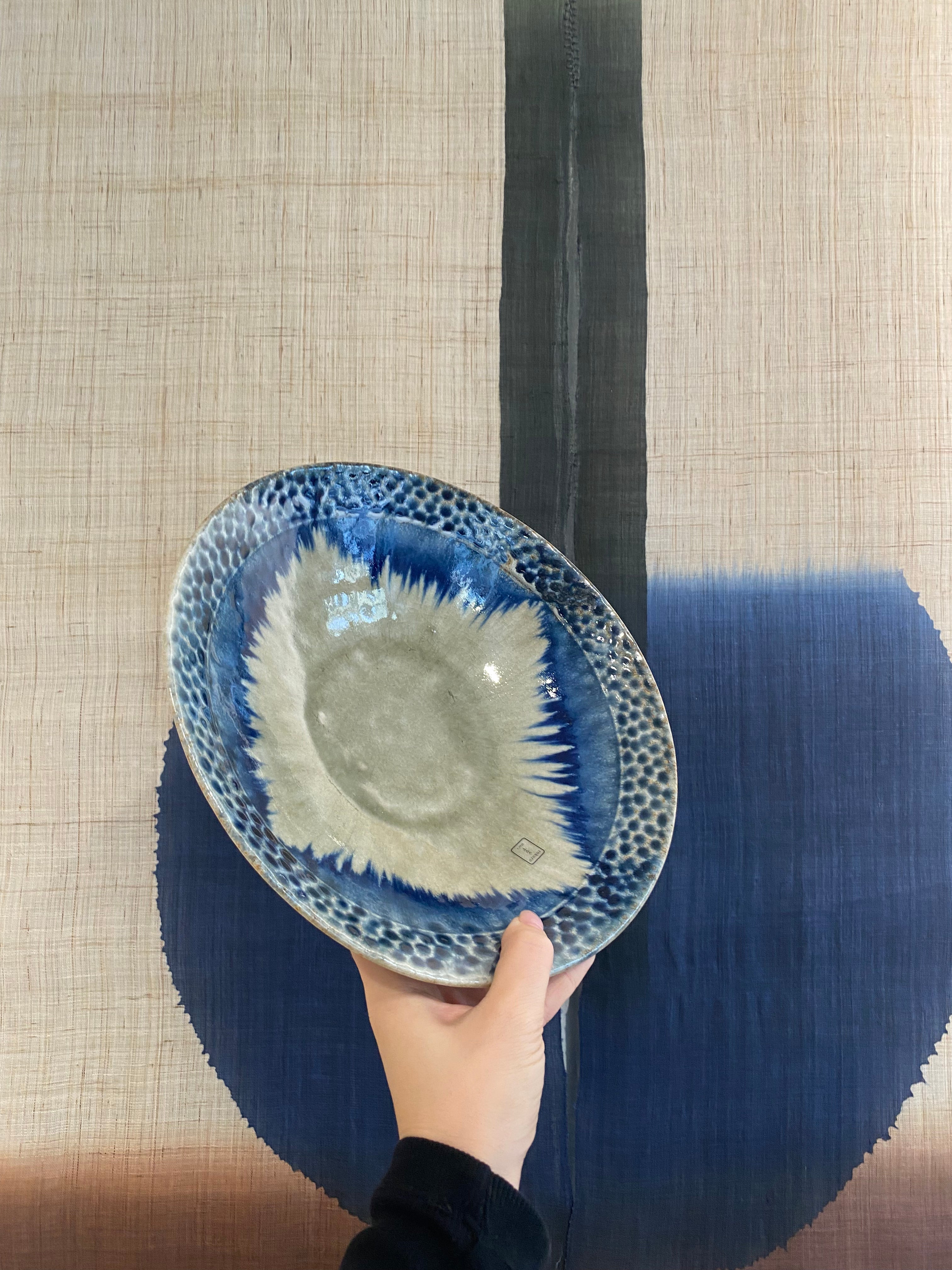 Large dish with greyish glaze and blue dots and details