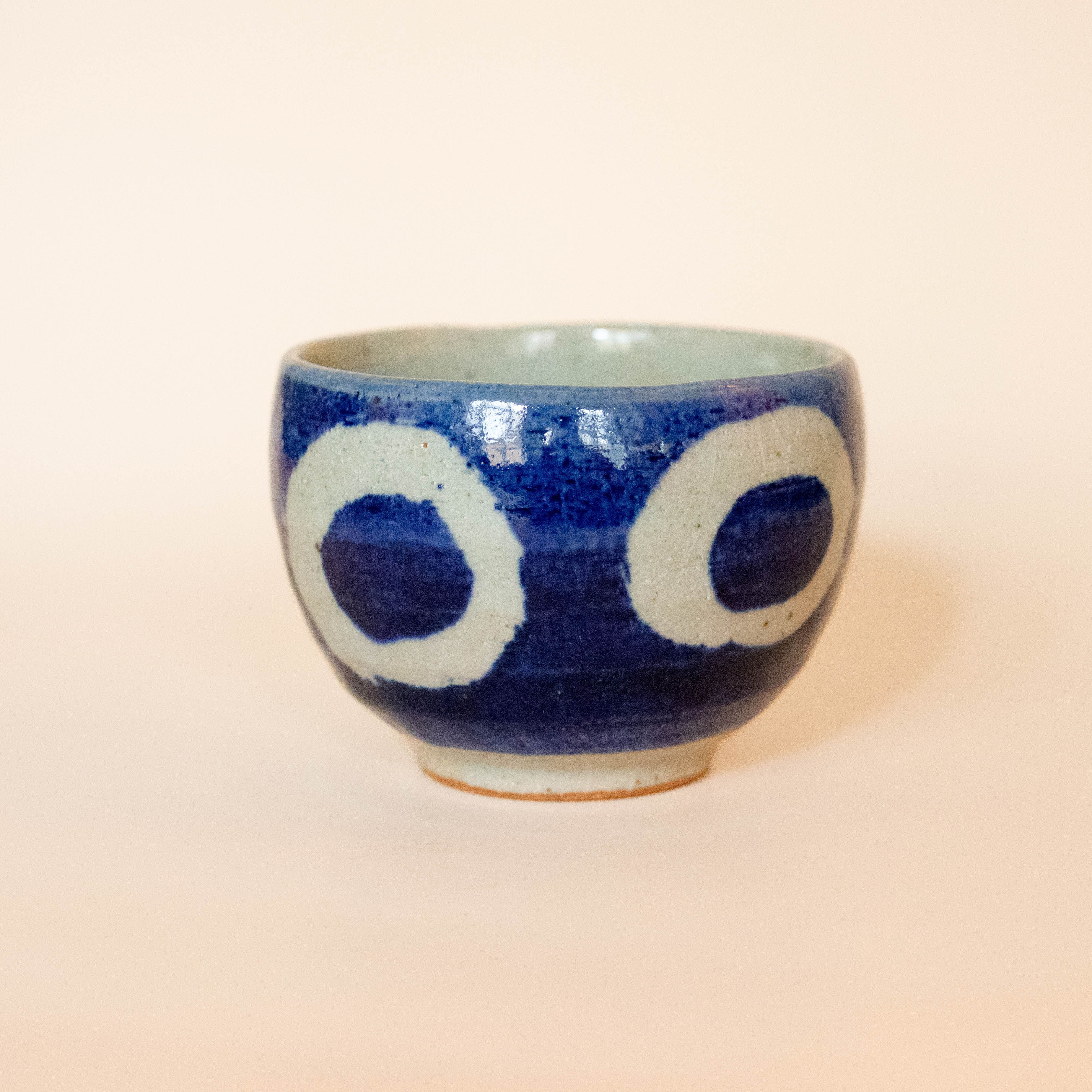 Blue ceramic cup with white circles