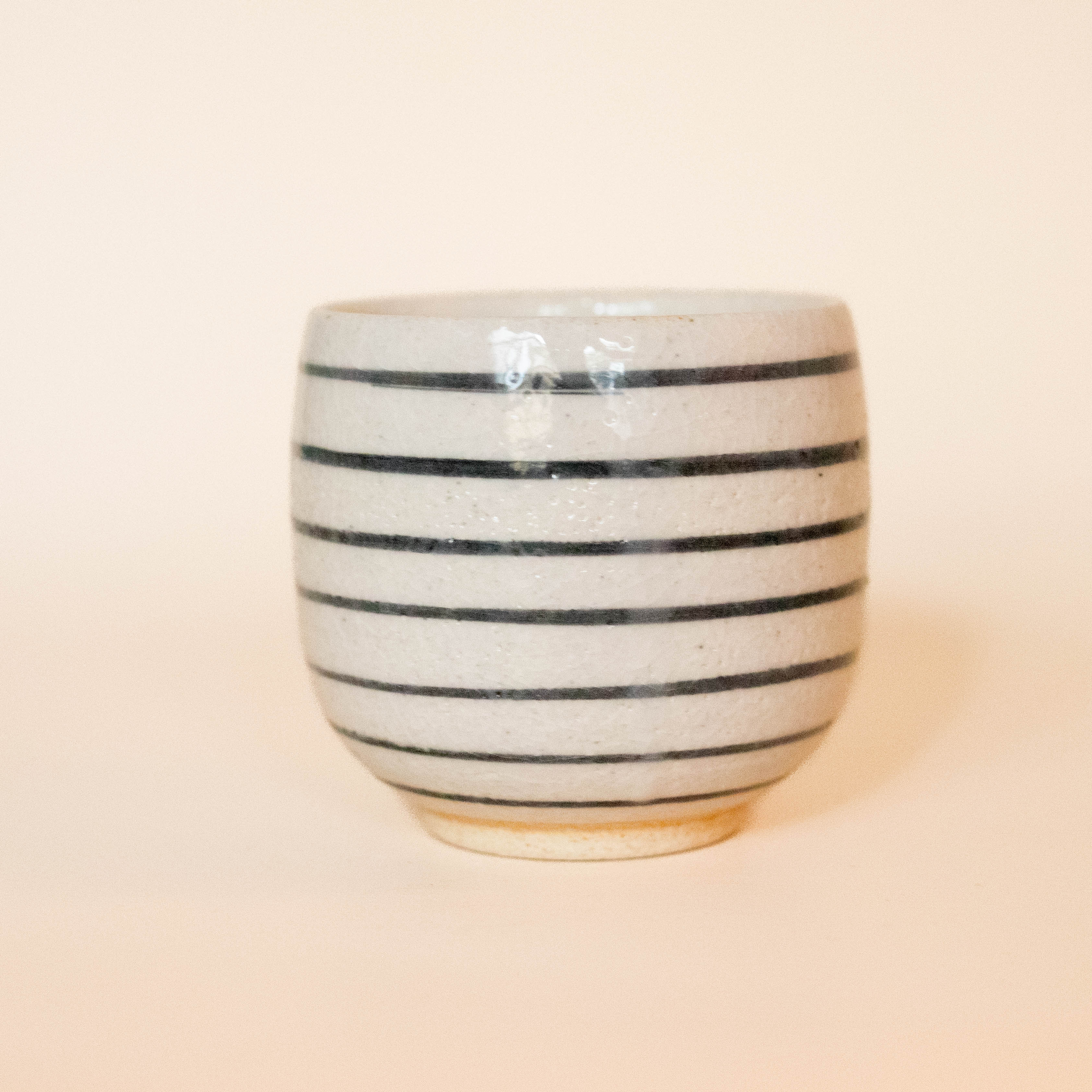 Small white cup with black stripes