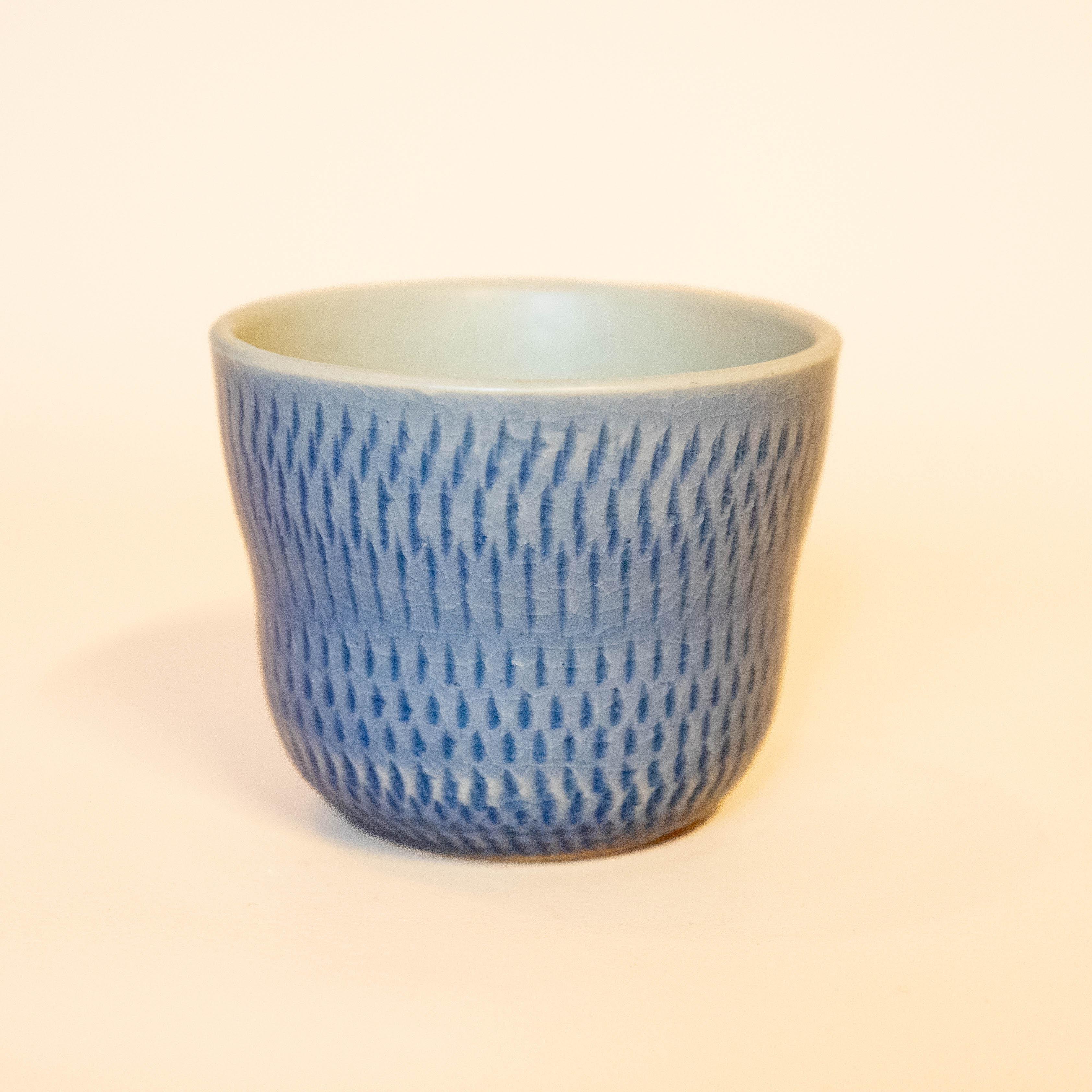 Japanese cup with blue glaze and line details