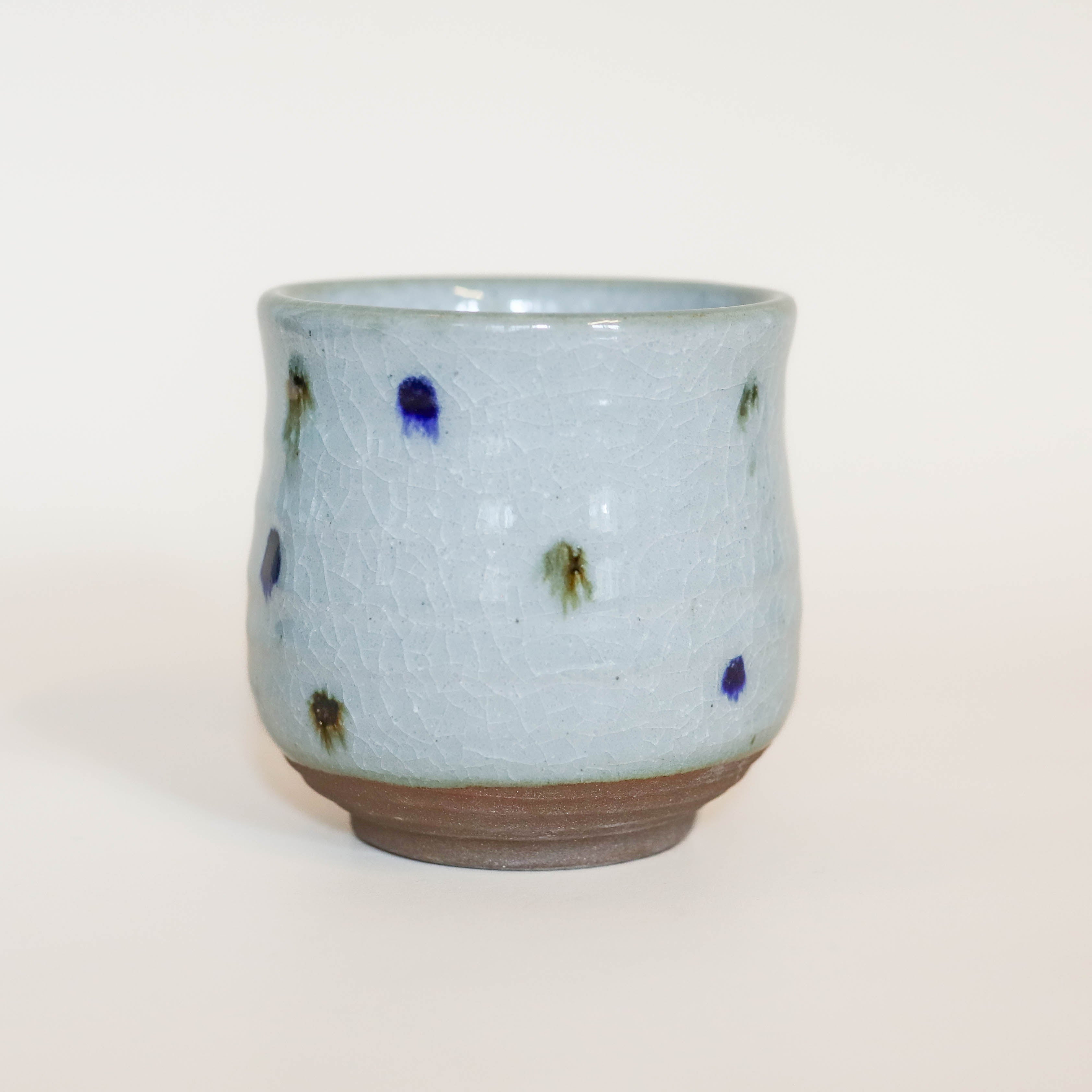 Gray cup with blue and brown dots