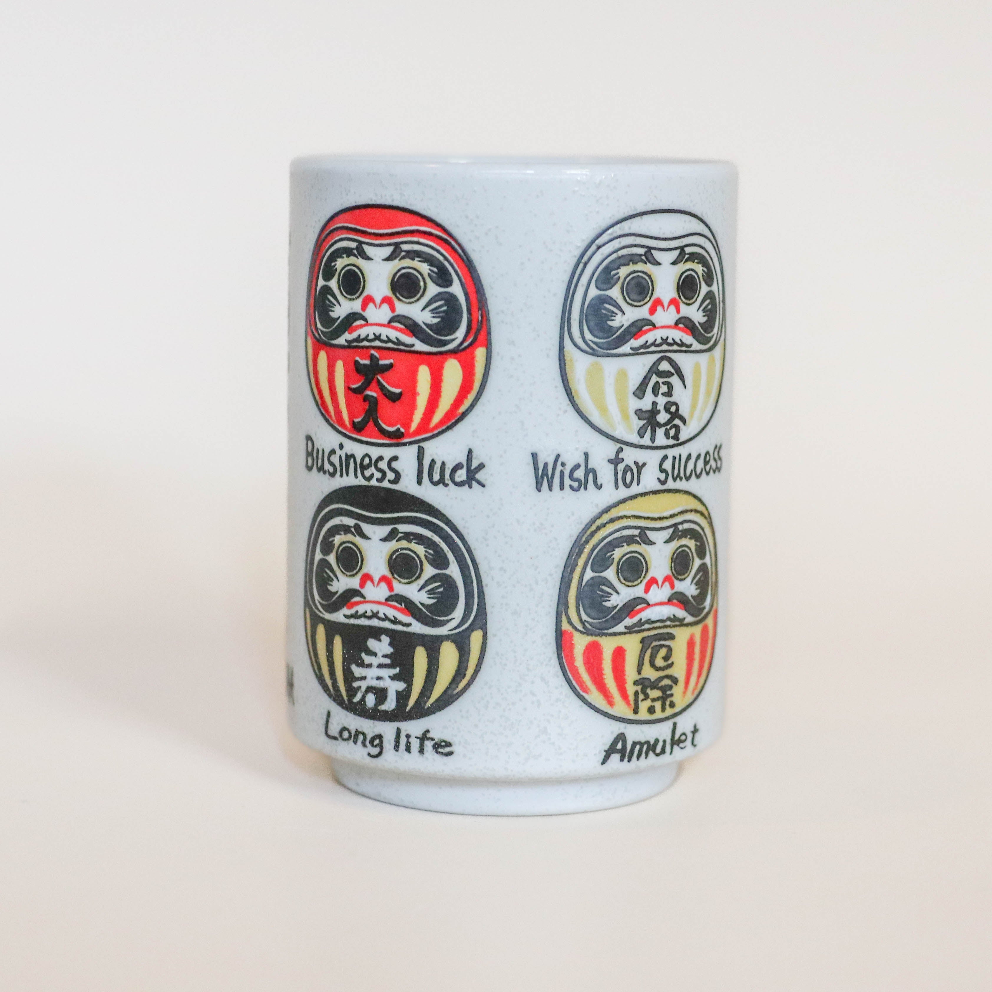 Cup with large Daruma in different colors