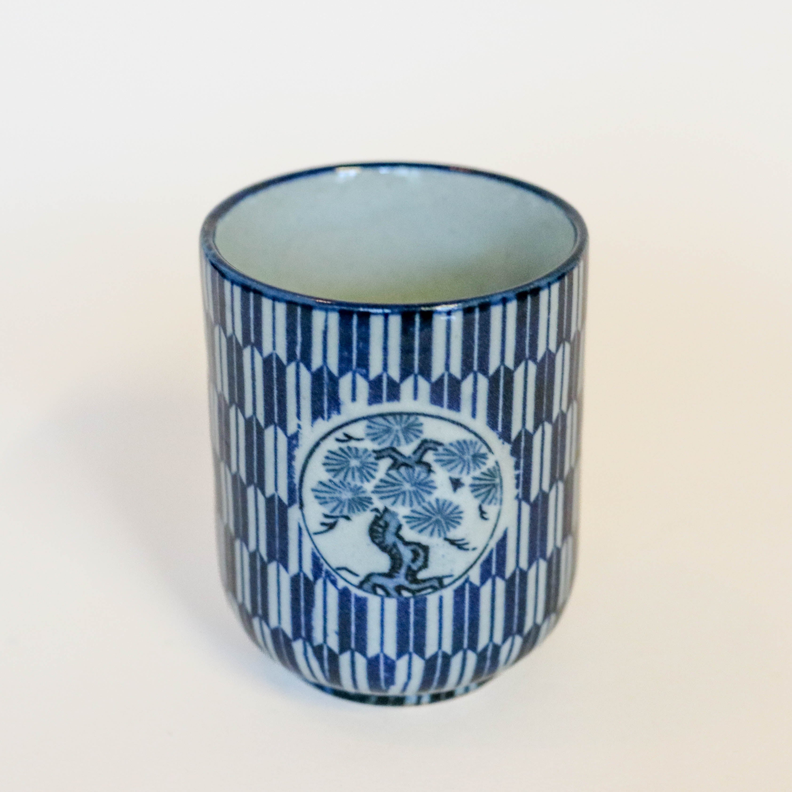 Narrow cup with blue Japanese motif