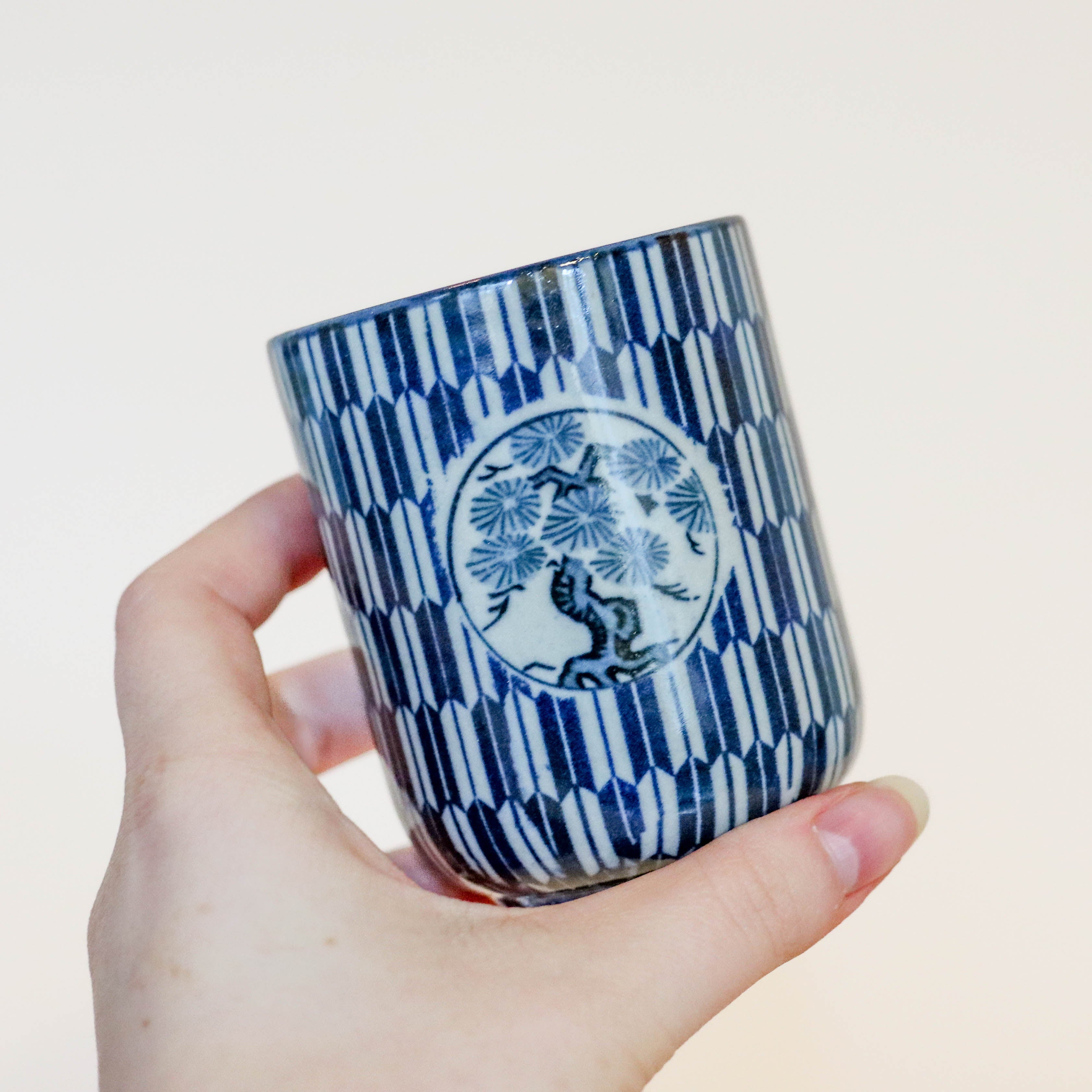 Narrow cup with blue Japanese motif