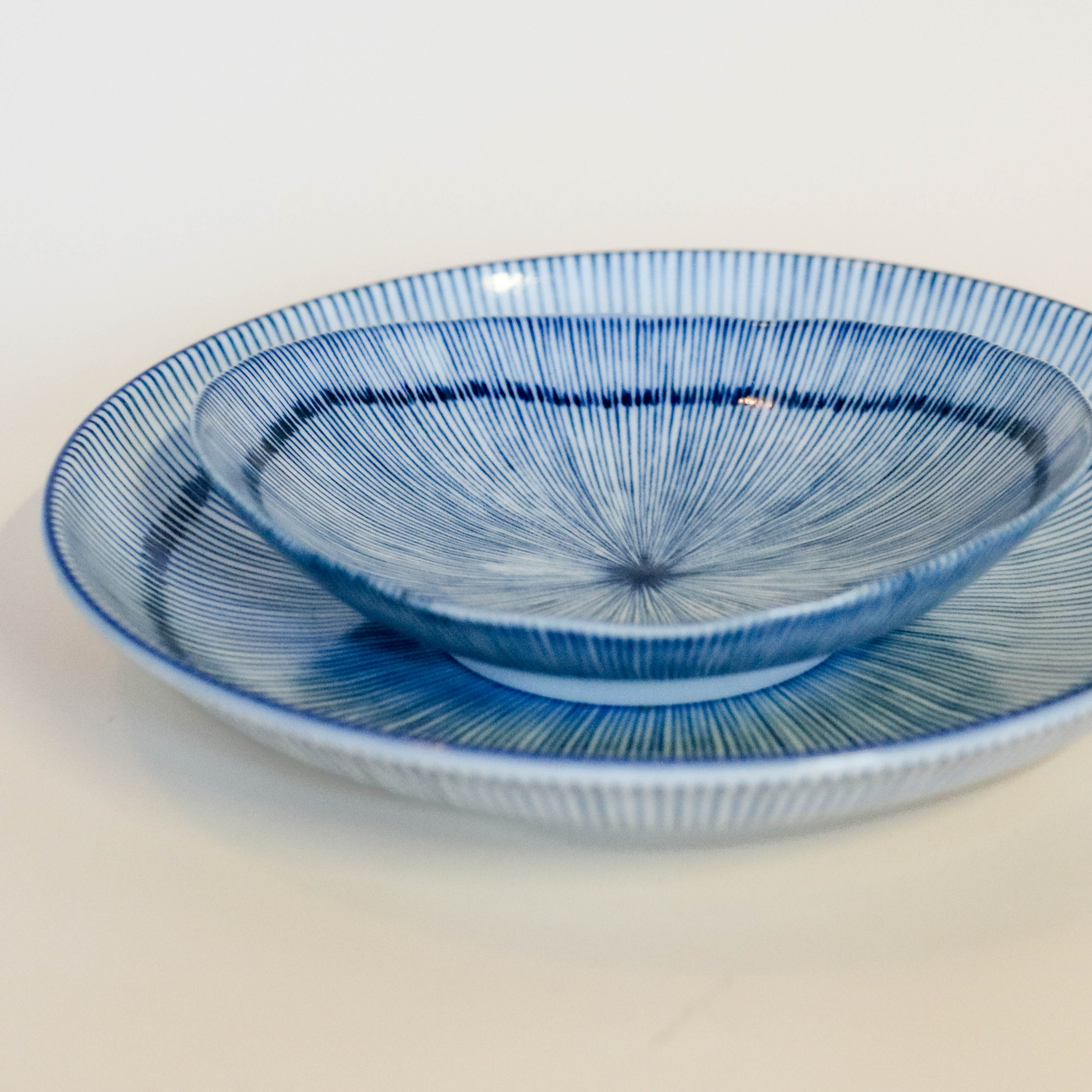 Small flat bowl with blue thin stripes