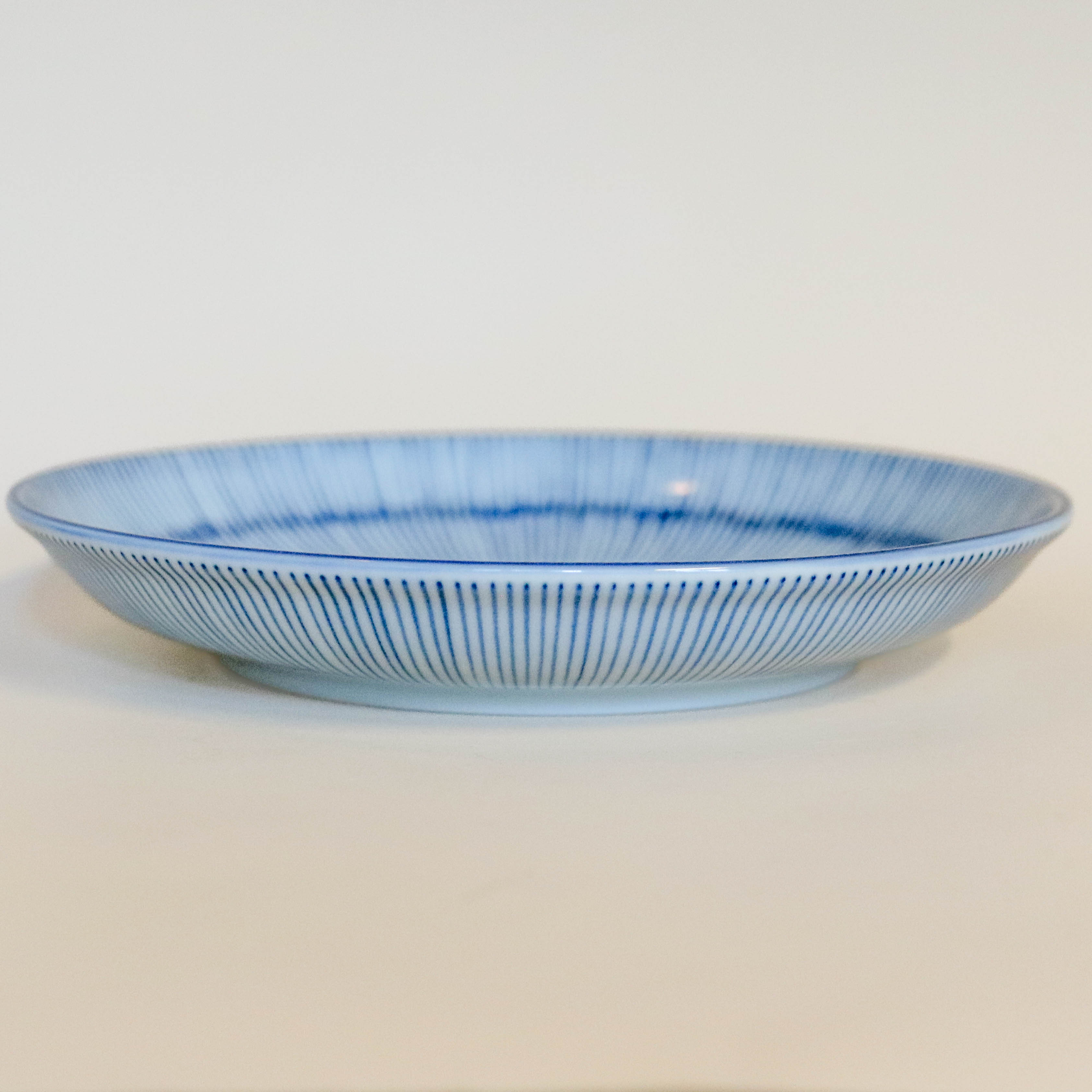 Deep plate/dish with thin blue stripes