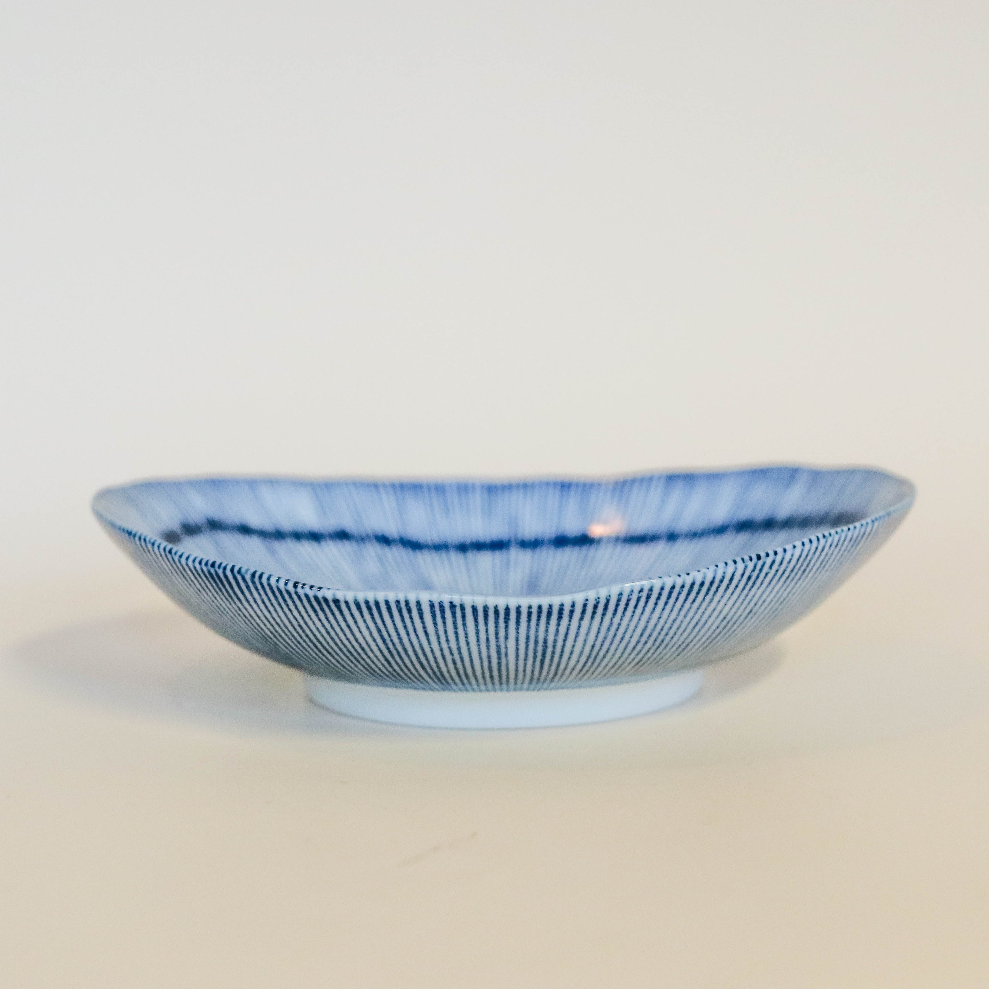 Small flat bowl with blue thin stripes