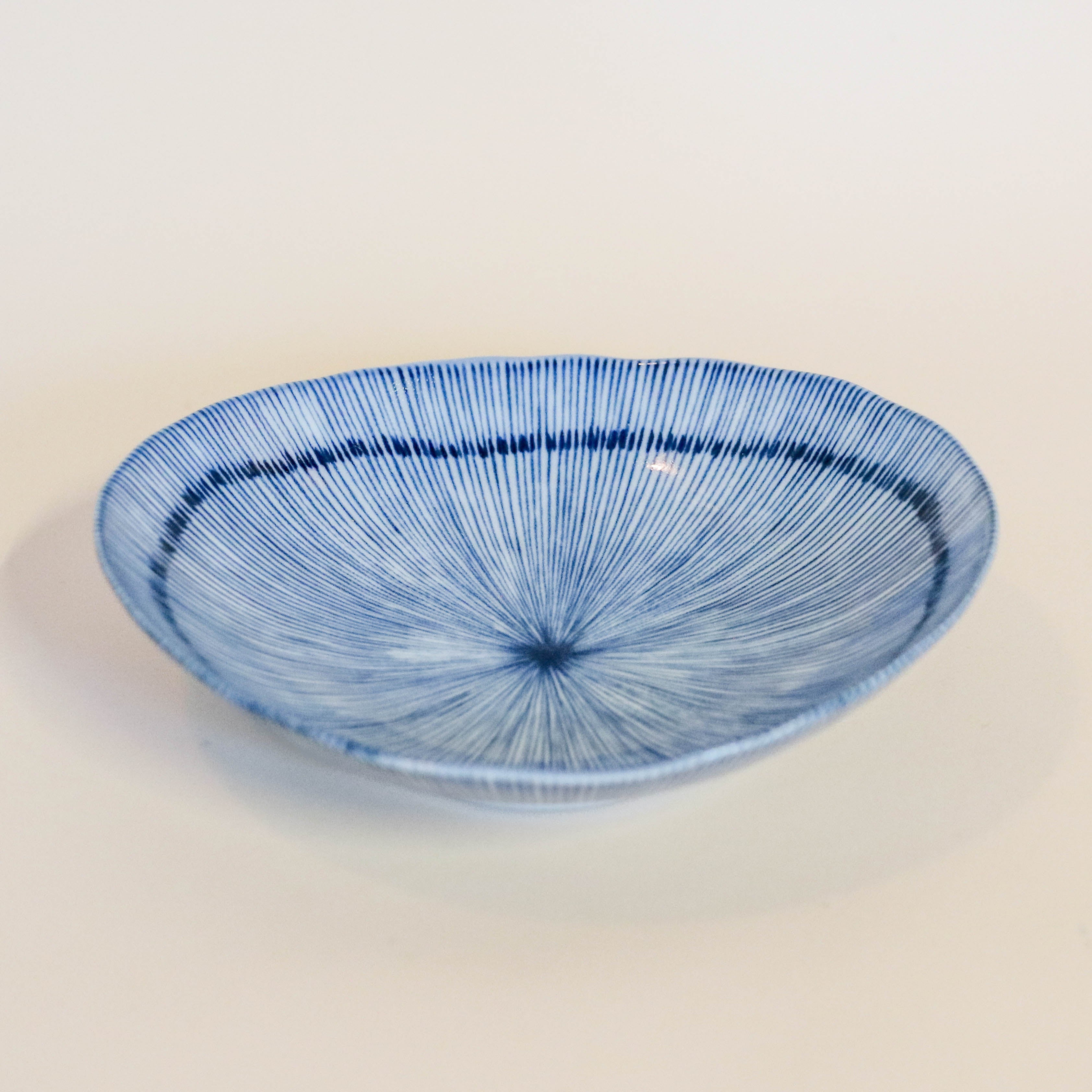 Small flat bowl with blue thin stripes