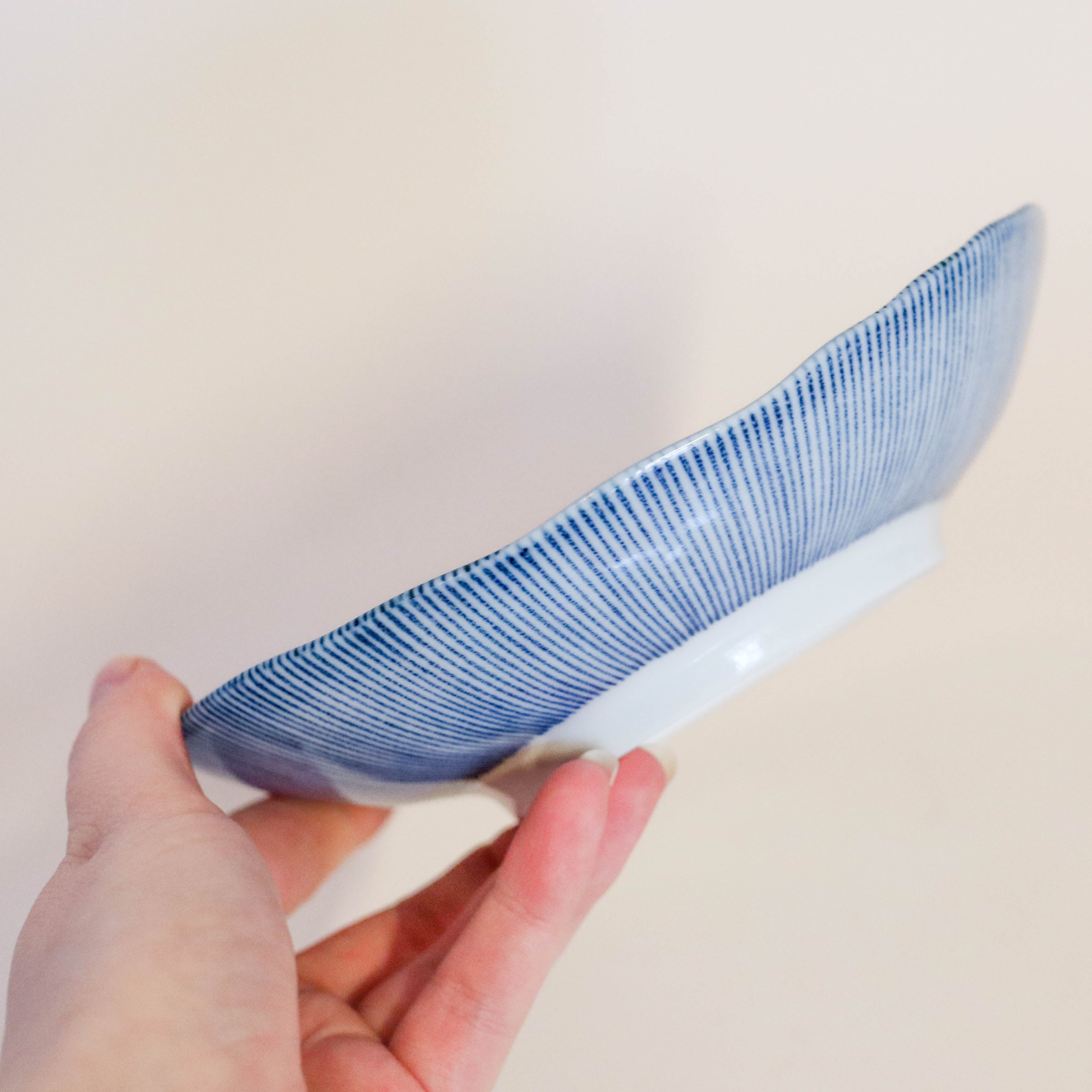 Small flat bowl with blue thin stripes