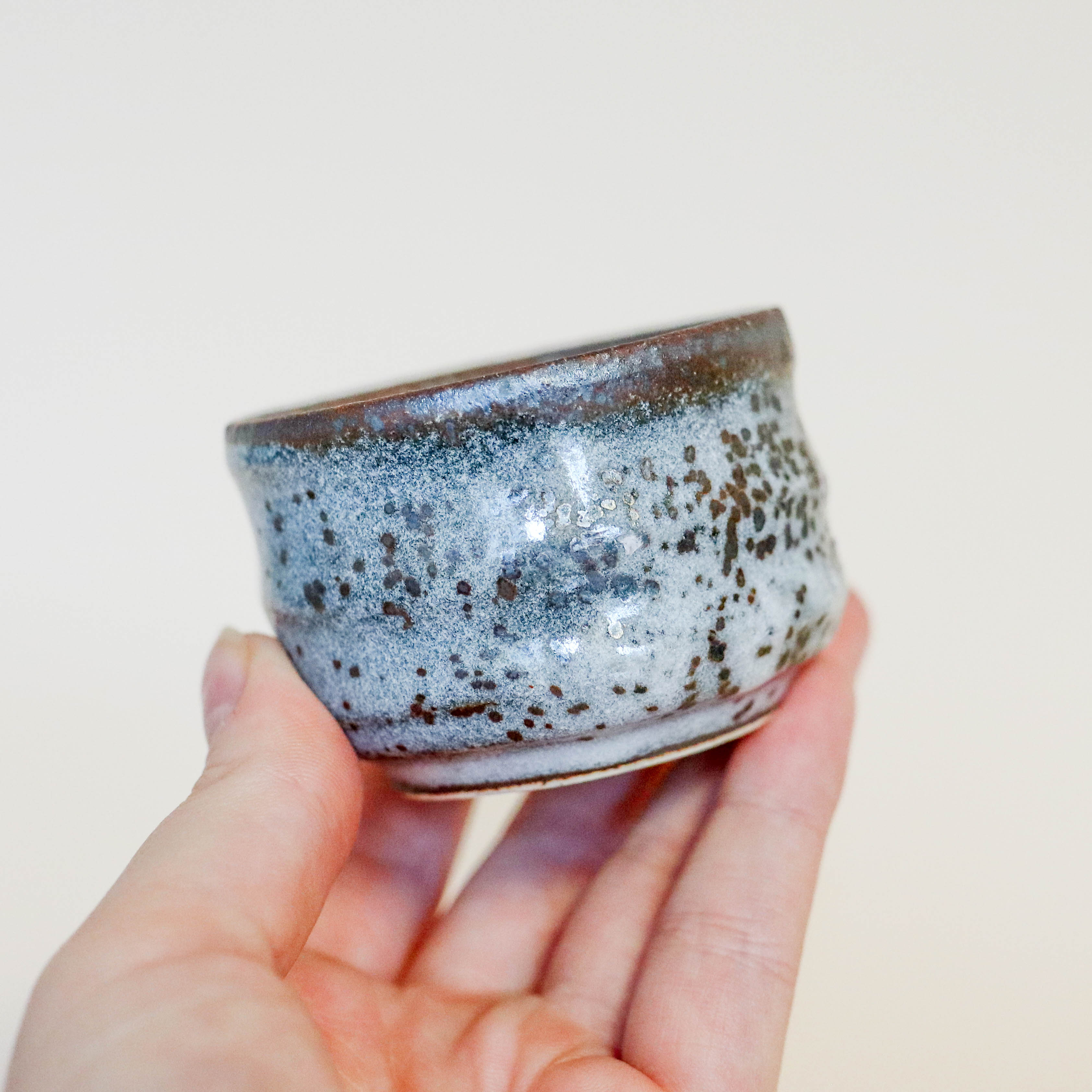 Small sake cup with gray glaze and Japanese motif