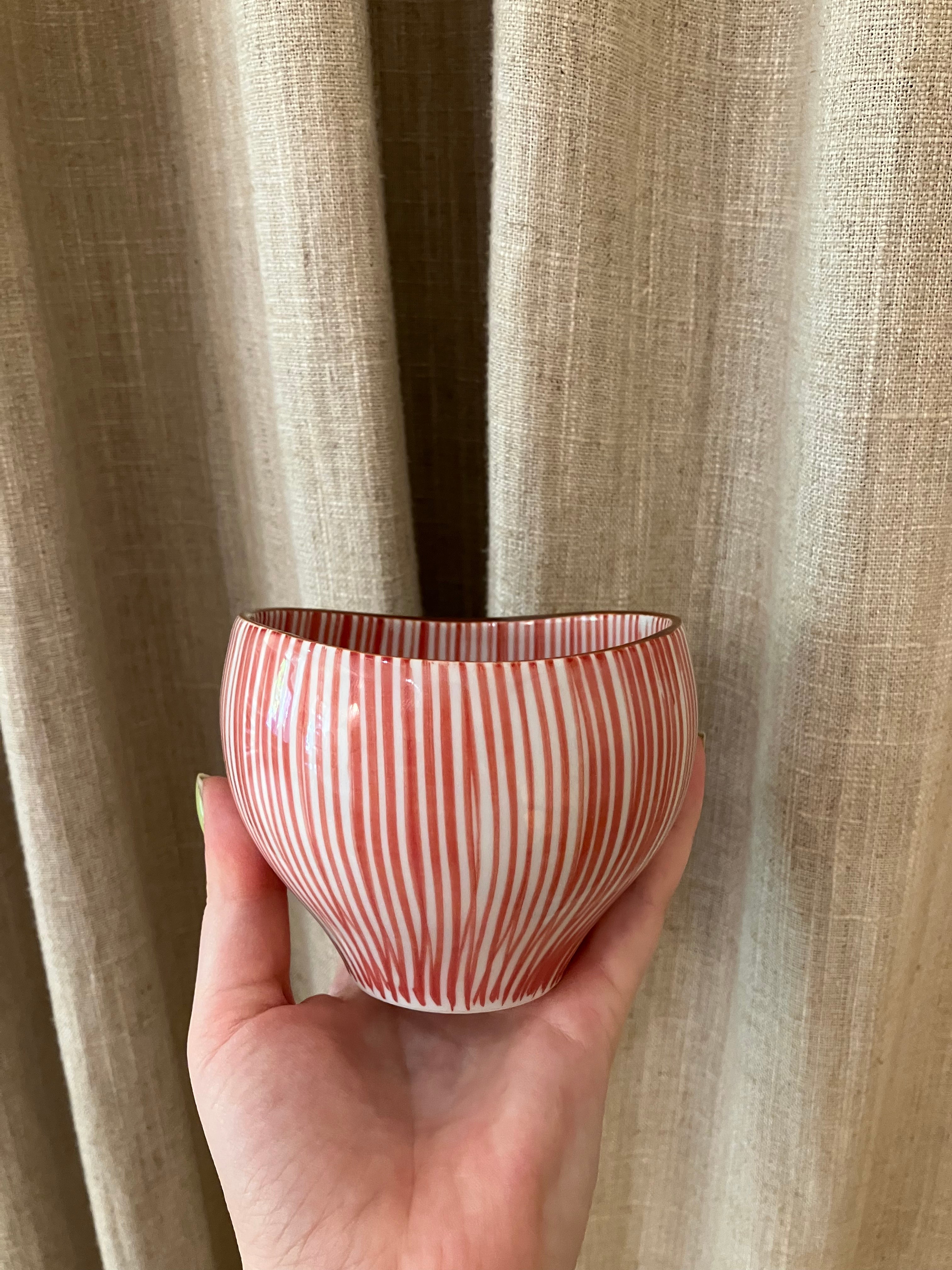 Cup with red vertical stripes and brown rim