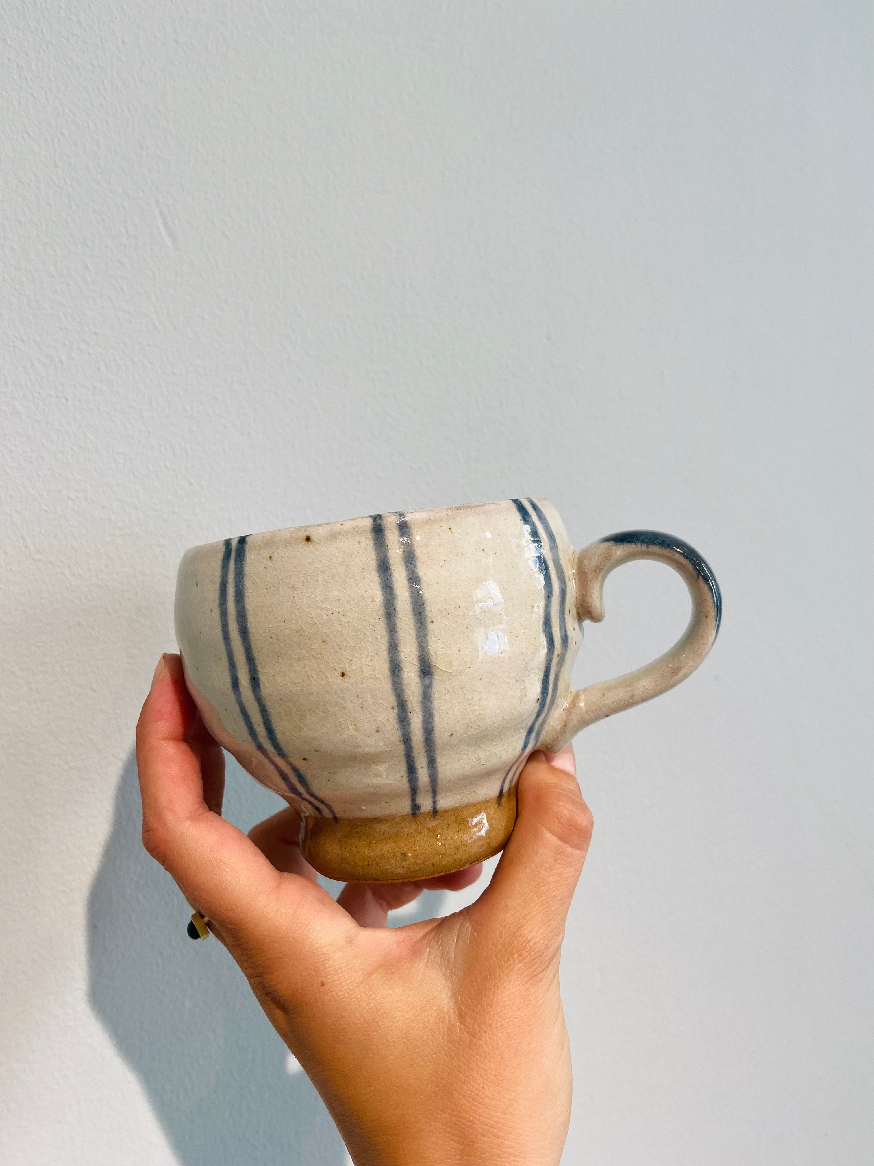 Hand painted ceramic cup with blue stripes