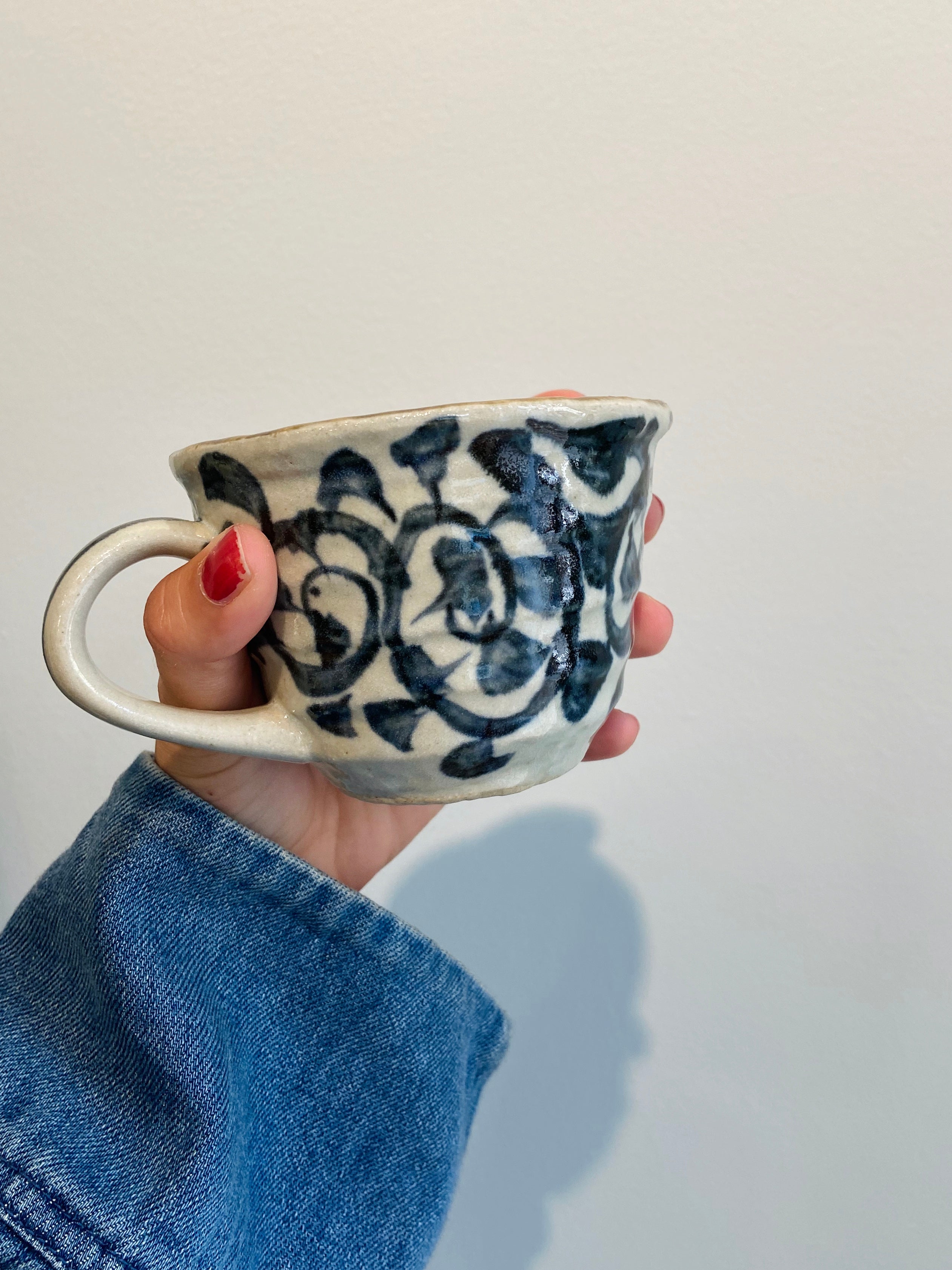 Rustic cup with hand-painted blue pattern