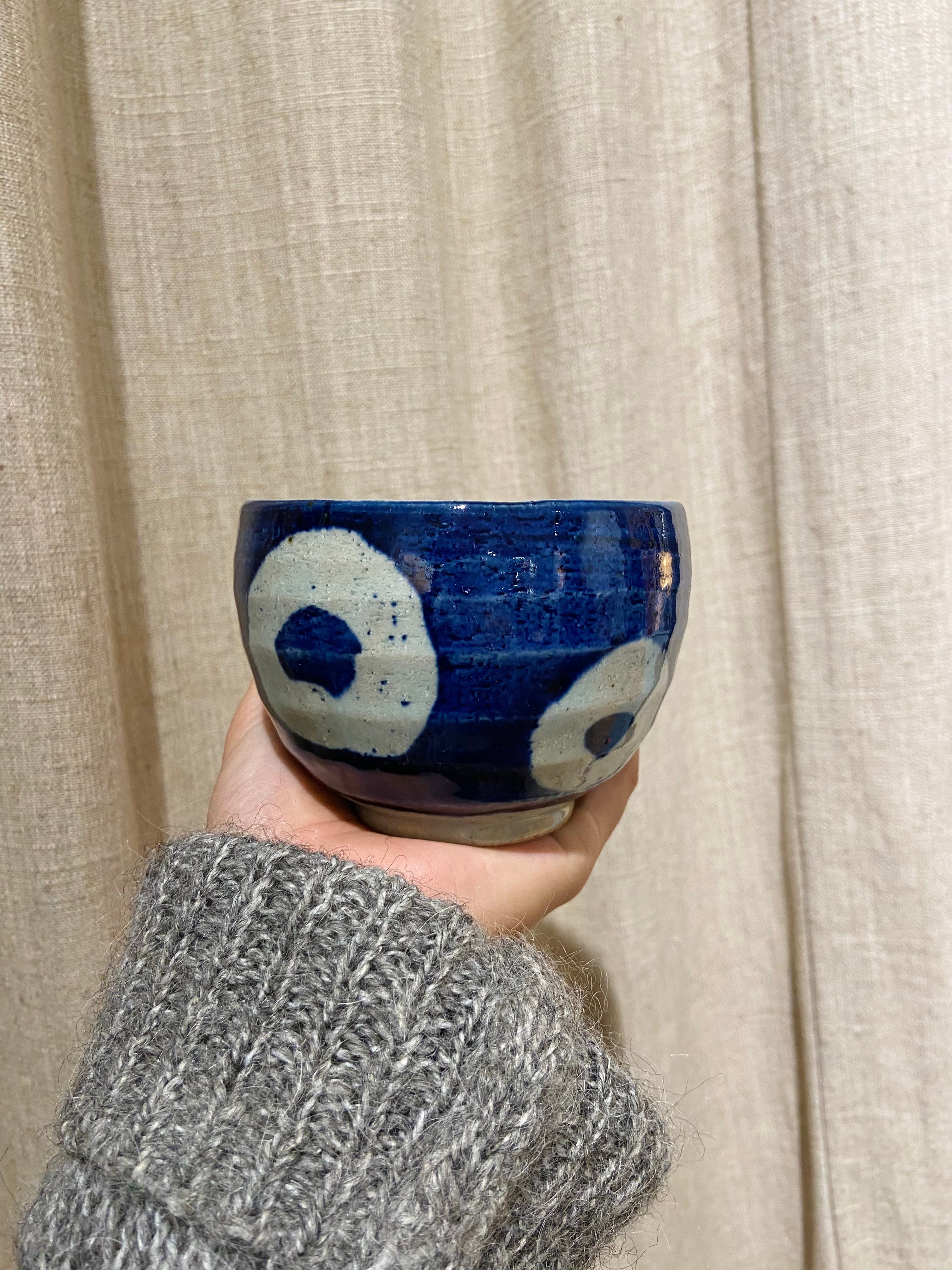 Blue ceramic cup with white circles