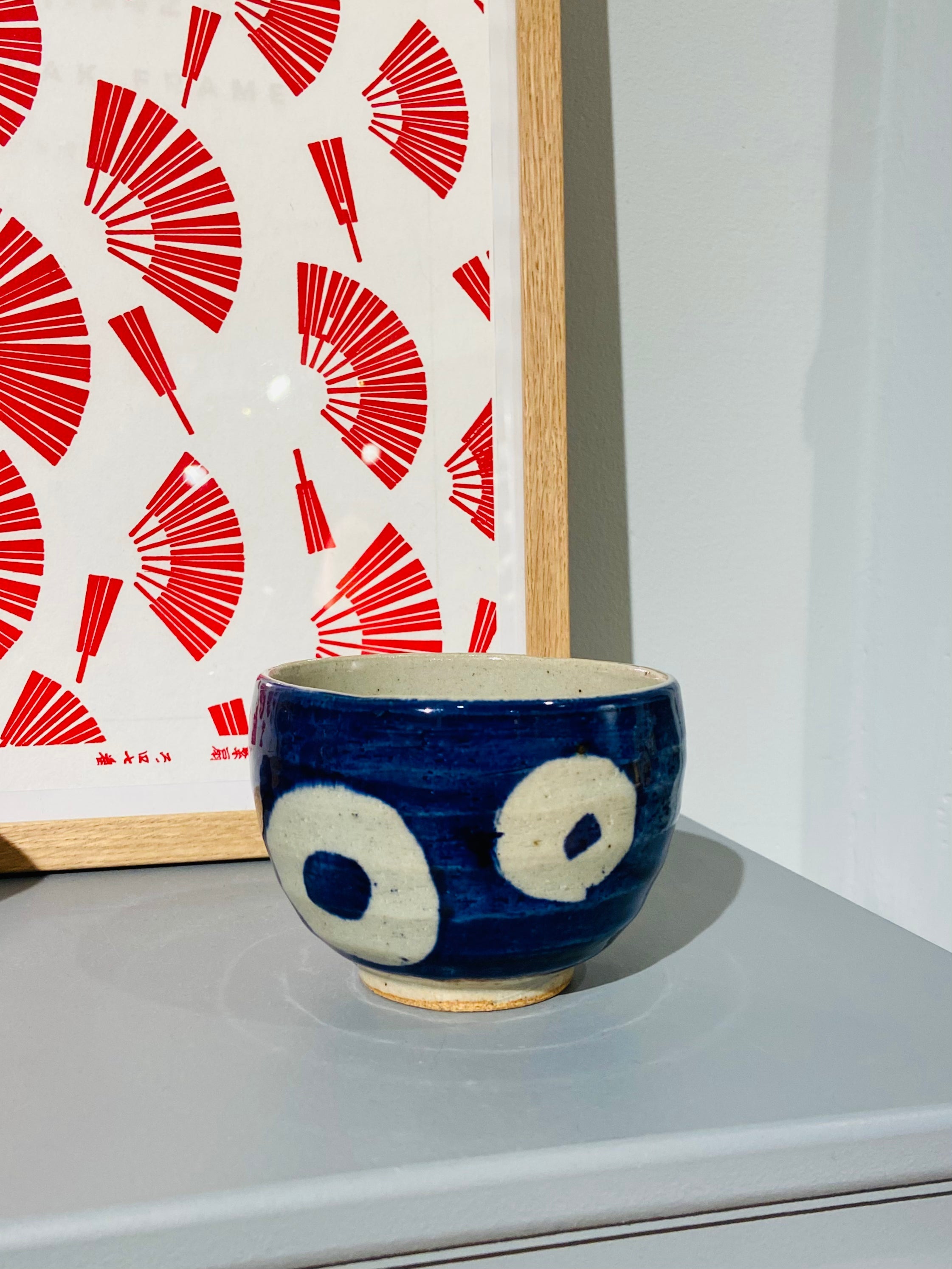 Blue ceramic cup with white circles