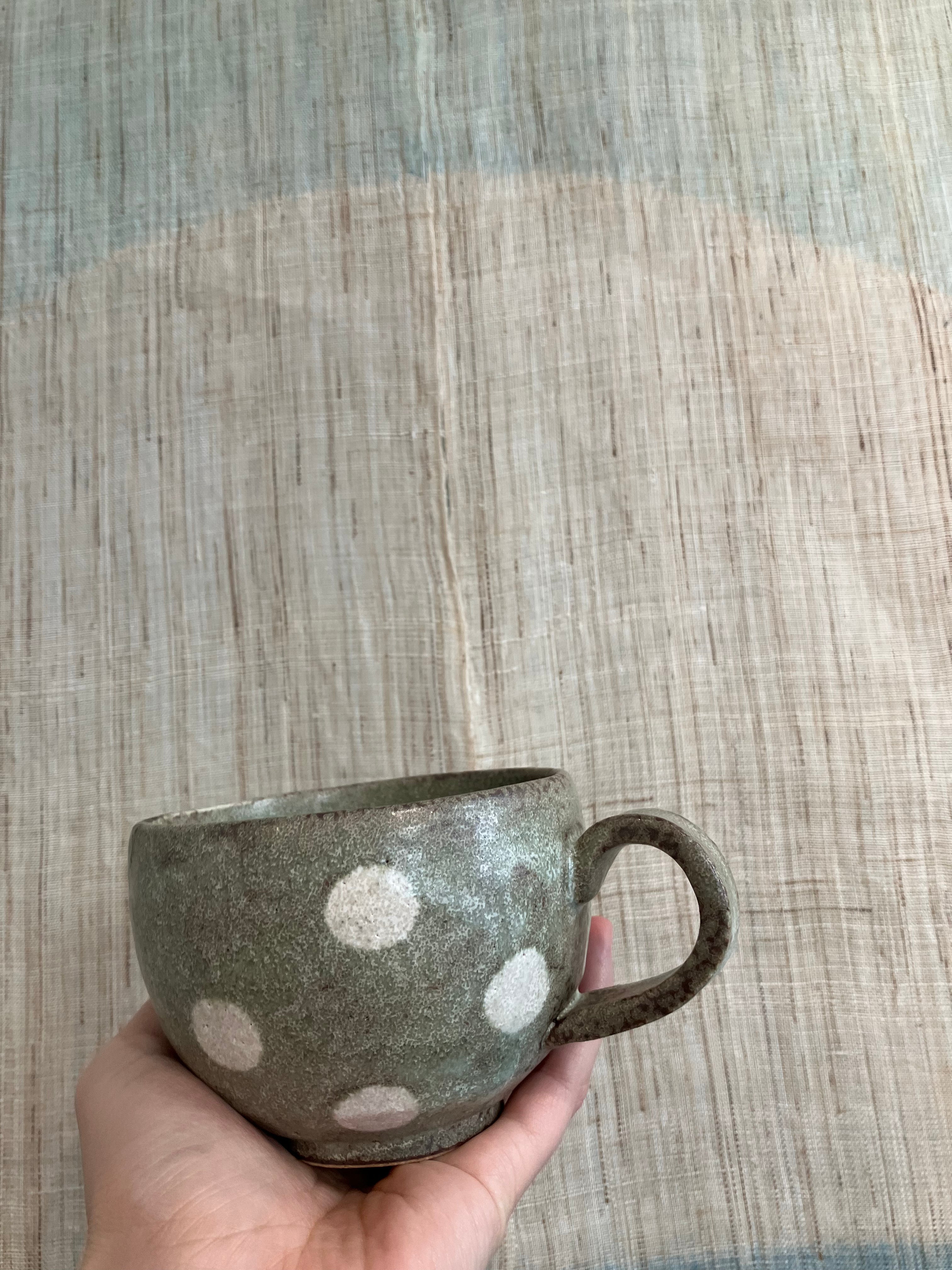 Japanese ceramic cup with green glaze and white dots