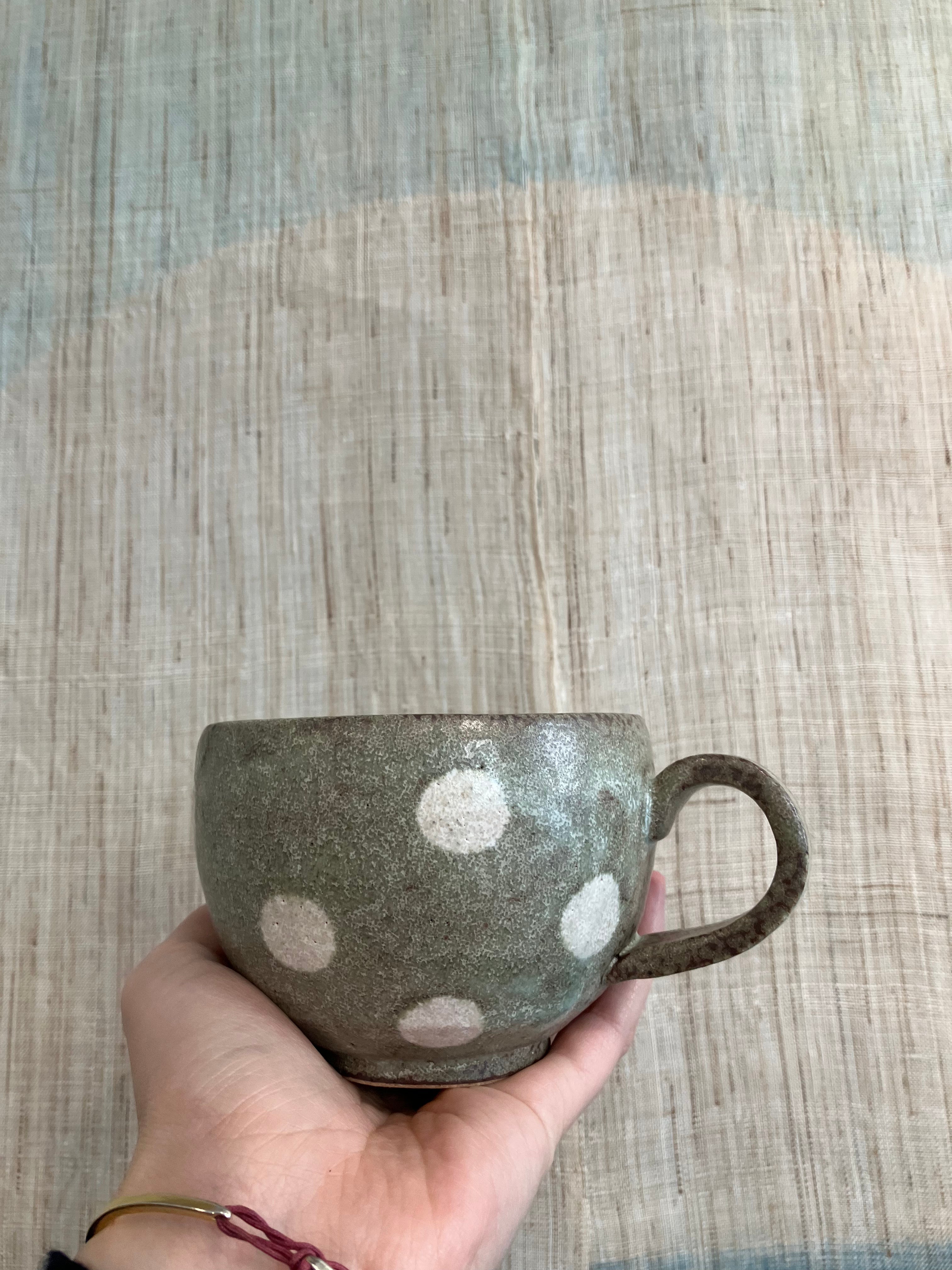 Japanese ceramic cup with green glaze and white dots