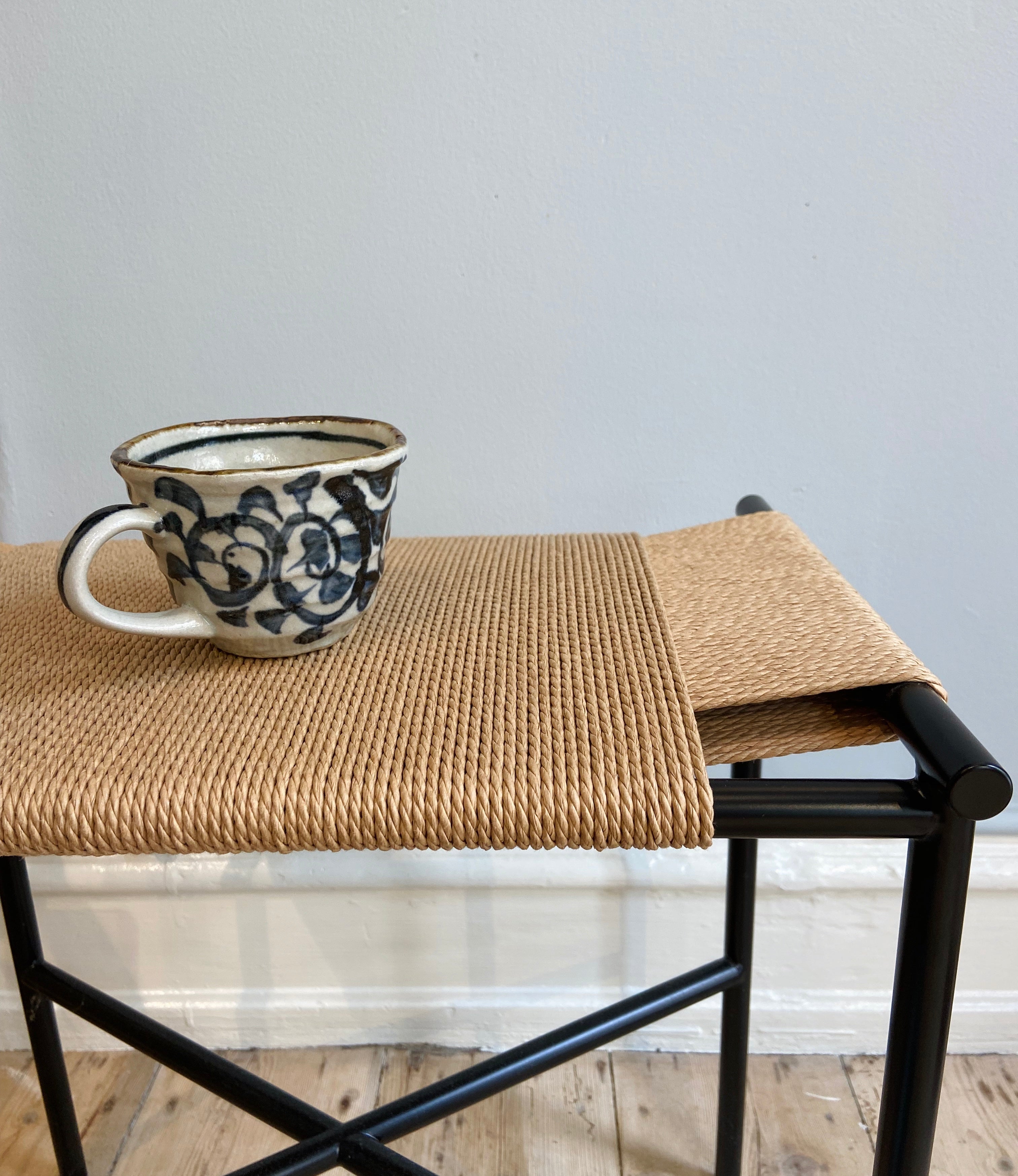 Rustic cup with hand-painted blue pattern