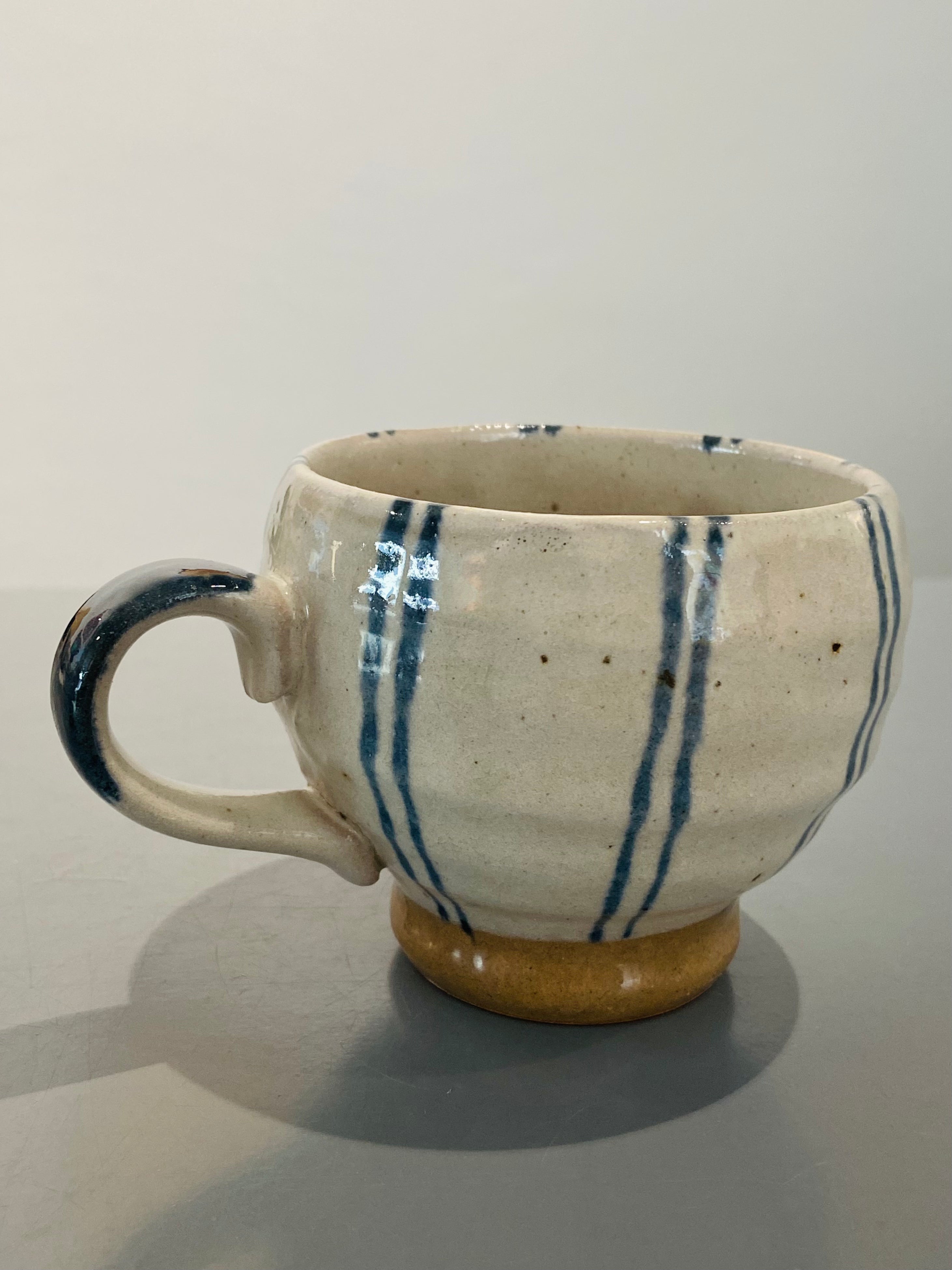 Hand painted ceramic cup with blue stripes